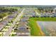 Aerial perspective of a vibrant community featuring single Gathering homes alongside a picturesque pond at 36673 Spanish Rose Dr, Dade City, FL 33525