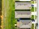 An aerial view of neighborhood homes shows well-maintained lawns and close proximity to a tranquil pond at 36673 Spanish Rose Dr, Dade City, FL 33525