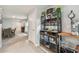 Stylish bar area with shelving and glassware, adjacent to the entryway at 36673 Spanish Rose Dr, Dade City, FL 33525