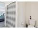View of the toilet, and shower-tub with a patterned curtain in the home's bathroom at 36673 Spanish Rose Dr, Dade City, FL 33525