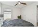 Bedroom features a ceiling fan, a window, and a bed with wooden drawer nightstand with lamps at 36673 Spanish Rose Dr, Dade City, FL 33525