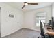 Bedroom includes a ceiling fan, gray carpet, and a desk with a computer workstation setup at 36673 Spanish Rose Dr, Dade City, FL 33525