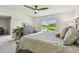 Bedroom with a large window with an outdoor view, dresser, ceiling fan, and a decorative plant at 36673 Spanish Rose Dr, Dade City, FL 33525
