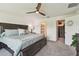 Bedroom featuring a ceiling fan, view of the backyard, access to the closet and bathroom at 36673 Spanish Rose Dr, Dade City, FL 33525