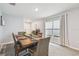 Formal dining room showcasing a wooden table set for a meal and bright window at 36673 Spanish Rose Dr, Dade City, FL 33525