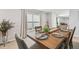 Dining room with a wooden table, seating for six, and natural lighting at 36673 Spanish Rose Dr, Dade City, FL 33525