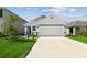 Charming single-story home with a well-manicured lawn and two-car garage at 36673 Spanish Rose Dr, Dade City, FL 33525