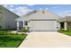 Charming single-Gathering home featuring a two-car garage, manicured lawn, and neutral color scheme at 36673 Spanish Rose Dr, Dade City, FL 33525