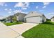 Well-maintained single Gathering home with attached garage and spacious, neatly manicured front yard at 36673 Spanish Rose Dr, Dade City, FL 33525