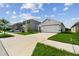 Lovely single-Gathering home with a well-maintained lawn and a long driveway leading to a two car garage at 36673 Spanish Rose Dr, Dade City, FL 33525