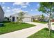Charming one-story home with well-manicured lawn and a large driveway leading to the attached garage at 36673 Spanish Rose Dr, Dade City, FL 33525