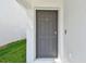 Close-up of a modern gray front door with a secure lock at 36673 Spanish Rose Dr, Dade City, FL 33525