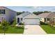 A single-Gathering home with a well-manicured lawn, lush landscaping, and a two-car garage at 36673 Spanish Rose Dr, Dade City, FL 33525