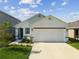 Charming single-Gathering home with a two-car garage, a well-maintained lawn, and beautiful landscaping at 36673 Spanish Rose Dr, Dade City, FL 33525