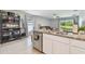 Open concept kitchen featuring granite countertops, stainless steel appliances, and convenient access to living area at 36673 Spanish Rose Dr, Dade City, FL 33525