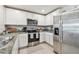Efficient kitchen with stainless steel appliances and white cabinetry at 36673 Spanish Rose Dr, Dade City, FL 33525
