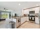 Well-equipped kitchen with stainless steel appliances and an open view to the living area at 36673 Spanish Rose Dr, Dade City, FL 33525