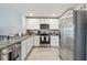 Bright kitchen with white cabinetry, granite countertops, stainless steel appliances, and ample counter space at 36673 Spanish Rose Dr, Dade City, FL 33525