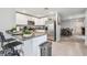Modern kitchen with white cabinets, granite countertops, stainless steel appliances, and a breakfast bar at 36673 Spanish Rose Dr, Dade City, FL 33525