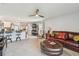Comfortable living room featuring a leather sofa, ceiling fan, and neutral color palette at 36673 Spanish Rose Dr, Dade City, FL 33525