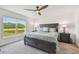 Spacious main bedroom featuring a large window, ceiling fan, and elegant furniture at 36673 Spanish Rose Dr, Dade City, FL 33525