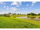 Scenic view of backyard pond showcasing the tranquil setting and the community's lush landscape at 36673 Spanish Rose Dr, Dade City, FL 33525