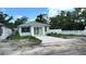 Attractive single-story house showcasing a bright exterior, newly poured driveway and white picket fence at 3704 Smith Tree St, Tampa, FL 33619