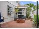 Private back patio featuring brick flooring, brick fire pit, chairs and coastal decor at 3800 6Th N Ave, St Petersburg, FL 33713