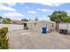 The home features a low maintenance backyard with neutral exterior and trash containers at 3800 6Th N Ave, St Petersburg, FL 33713