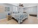 Bright bedroom with coastal decor, ceiling fan, and light wood-look flooring at 3800 6Th N Ave, St Petersburg, FL 33713