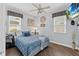 Cozy bedroom with wood floors, ceiling fan, and a TV showing a tropical beach scene at 3800 6Th N Ave, St Petersburg, FL 33713