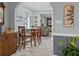 View of the dining area with wood table and chairs, leading to a living room with stone fireplace at 3800 6Th N Ave, St Petersburg, FL 33713