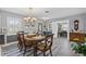 Bright dining room with a wooden table, chandelier, and herringbone floors adjacent to an office at 3800 6Th N Ave, St Petersburg, FL 33713