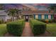 Charming home with a beautiful front garden and walkway lined with manicured hedges at 3800 6Th N Ave, St Petersburg, FL 33713