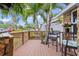 Cozy porch with chairs and a table, surrounded by lush greenery, perfect for outdoor relaxation at 3800 6Th N Ave, St Petersburg, FL 33713