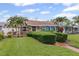 Attractive home with a well-maintained lawn, mature palm trees, and a cozy wooden porch at 3800 6Th N Ave, St Petersburg, FL 33713