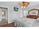Bright main bedroom showcasing a ceiling fan, dresser, and a glimpse into the en-suite bathroom at 3800 6Th N Ave, St Petersburg, FL 33713