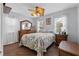 Comfortable bedroom with a tropical-themed comforter, ceiling fan, and natural light from the windows at 3800 6Th N Ave, St Petersburg, FL 33713