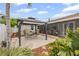 Cozy backyard patio with seating, pergola, landscaping, and access to the home's interior at 3800 6Th N Ave, St Petersburg, FL 33713