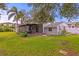 Large backyard with a screened-in patio and partial views of the home's exterior at 493 Lucerne Ave, Tampa, FL 33606
