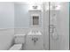Modern bathroom featuring an all white tiled shower, toilet, and sink at 493 Lucerne Ave, Tampa, FL 33606