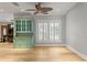 Bright dining room with green hutch, plantation shutters, and hardwood floors at 493 Lucerne Ave, Tampa, FL 33606