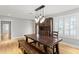 Dining area featuring a large wooden table and an elegant hanging light fixture at 493 Lucerne Ave, Tampa, FL 33606