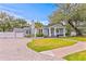 Charming single-story home with manicured lawn, gray exterior and driveway at 493 Lucerne Ave, Tampa, FL 33606