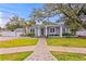 Charming home featuring a manicured lawn, covered entry, and stone walkway at 493 Lucerne Ave, Tampa, FL 33606
