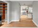 Hallway view toward kitchen featuring hardwood flooring, white trim, and bright, open spaces at 493 Lucerne Ave, Tampa, FL 33606