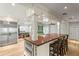 Open kitchen with island, wood countertop, stainless steel appliances, and hardwood floors at 493 Lucerne Ave, Tampa, FL 33606
