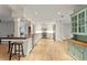 Open concept kitchen with white cabinets and stainless steel appliances at 493 Lucerne Ave, Tampa, FL 33606
