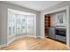Bright laundry room featuring modern machines, bay window with plantation shutters, and custom wood shelving at 493 Lucerne Ave, Tampa, FL 33606