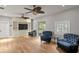 Living room featuring hardwood floors, built-in shelving, and two oversized chairs at 493 Lucerne Ave, Tampa, FL 33606